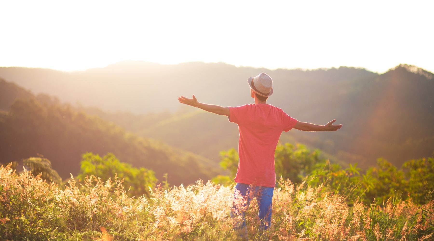 Man standing on a hill filled with vitality thanks to Rose-Hip Vital